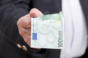 front view of 100 euro banknote in businessman hand close up
