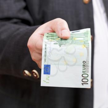 front view of 100 euro banknote in male hand close up