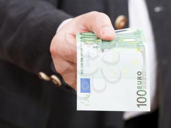 front view of hundred euro banknote in hand close up