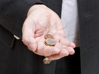 pile of coins in businessman's hand close up