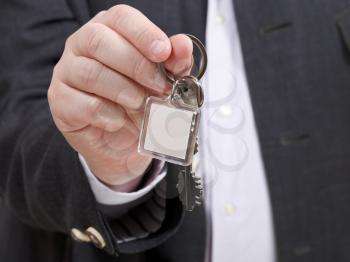 front view of businessman hand with blank door keychain close up