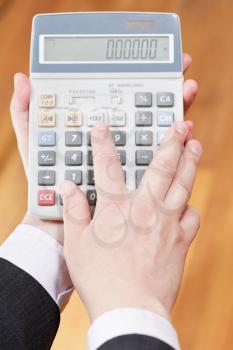 above view of calculator in accountant hands close up