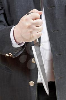 front view of knife in businessman hand close up