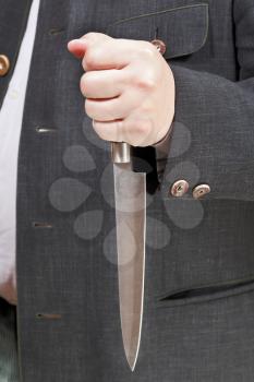 kitchen knife in businessman hand close up