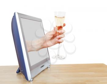 hand holding glass with champagne leans out TV screen isolated on white background