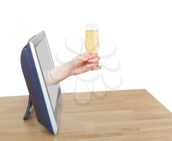 hand holds wineglass with sparkling wine leans out TV screen isolated on white background