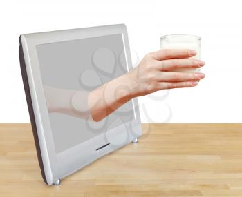 hand holding glass of milk leans out TV screen isolated on white background
