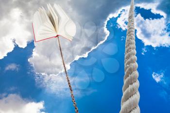 rope rises to sky and book tied on rope soars into dark sky