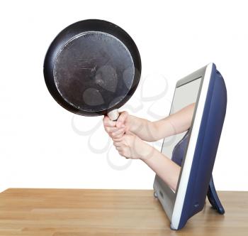 black skillet in female hands leans out TV screen isolated on white background