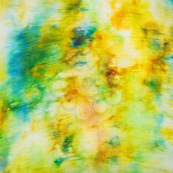 batik - abstract yellow and green painted spots on silk fabric