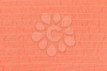 coral color textile texture of stitched silk fabric