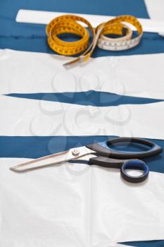 tailor tools and master forms of dress on blue fabric for dress cutting