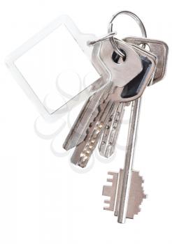 bunch of apartment keys on steel ring and keychain isolated on white background