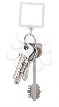 bunch of keys on ring and square keychain isolated on white background