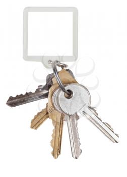 bunch of door keys on ring and square keychain isolated on white background