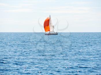 yacht with red sail in blue Adriatic sea, Dalmatia, Croatia