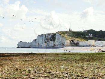 view of Etretat village and cliff on english channel beach of cote d'albatre, France