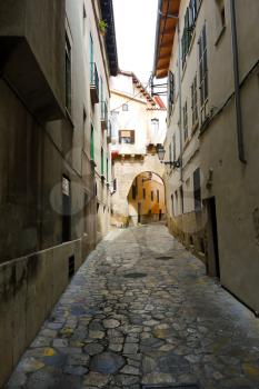 narrow medieval stone street in city Palma de Mallorca, Spain