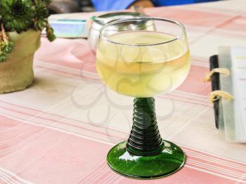 glass of local dry white wine on restaurant table in Moselle region, Germany