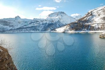 mountain Lake Lac du Chevril in Tarentaise Valley in winter, Paradiski skiing region, France