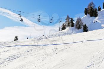 ski lift and slope of Dolomites mountains in Val Gardena, Italy