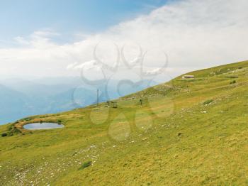 green slope of Monte Baldo mountains in summer day, Lake garda region, Alps, Italy