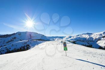 skiing tracks on snow slopes of mountains in sunny day in Portes du Soleil region, Morzine - Avoriaz, France