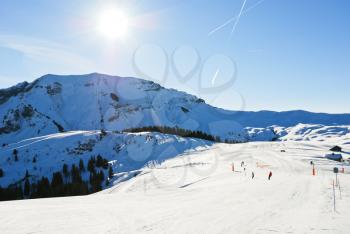 downhill skiing on snow slopes of mountains in sunny day in Portes du Soleil region, Morzine - Avoriaz, France