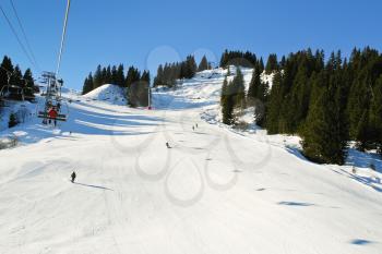 ski lift and skiing tracks on snow slopes of mountains in Portes du Soleil region, Morzine - Avoriaz, France