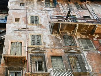 shabby facade of old house in center of Verona city, Italy