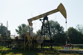 pumpjack pumps oil in the foothills of the Caucasus mountain