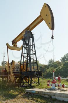 pumpjack pumps oil in foothills of Caucasus mountain