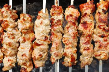 skewers with meat shish kebabs on brazier close up