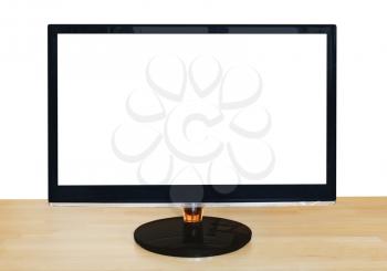 front view of computer black widescreen display with cut out screen on wooden table isolated on white background