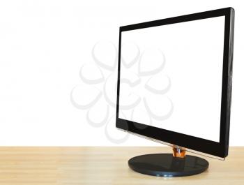 side view of computer black widescreen display with cut out screen on wooden table isolated on white background