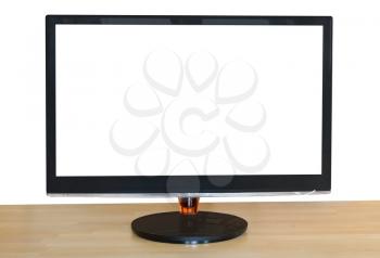 front view of computer black widescreen display with cutout screen on wood table isolated on white background