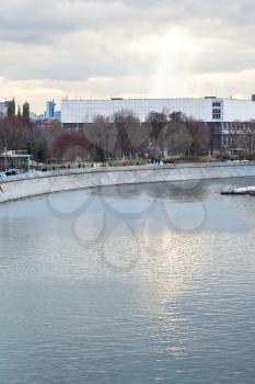 Moskva River, Yakimanskaya embankment and rays of the sun illuminating building of the State Tretyakov Gallery at Krymsky Val in cloudy autumn evening