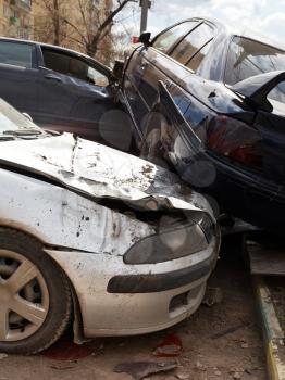 three broken cars during road accident on urban street