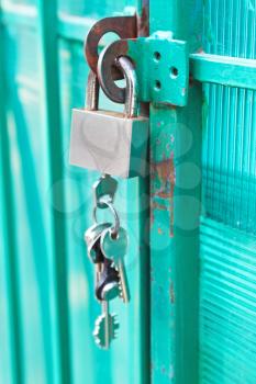padlock with bunch of keys hanging on the door