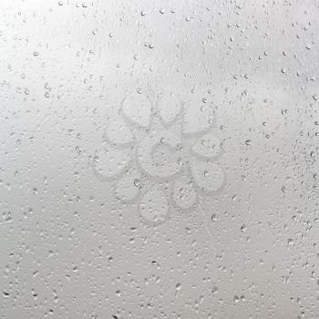 background from rain drops on window pane in cloudy day