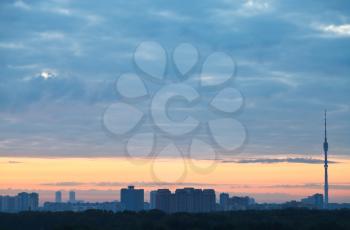 blue clouds and yellow sunrise sky over city, Moscow
