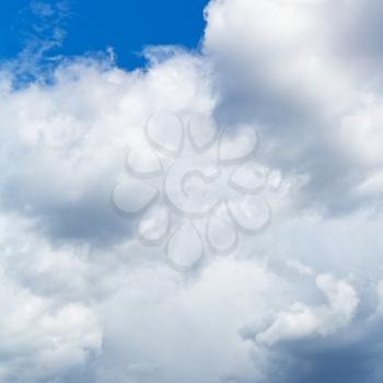 heavy cumuli clouds in blue sky in summer day