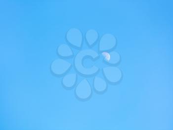 half of moon in clear blue autumn sky - natural background
