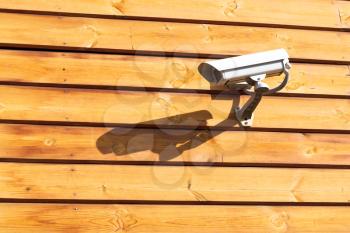 Surveillance cameras on wall of wooden log house