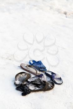 frozen slippers near snow edge of ice hole during religious orthodox epiphany holiday