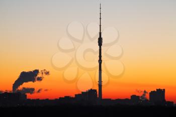 view TV tower and early morning yellow and orange sunrise sky in Moscow