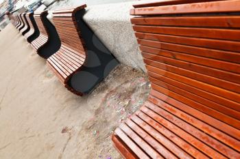 empty wooden benches on urban embankment