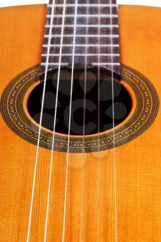 body of classical acoustic guitar with six nylon strings close up
