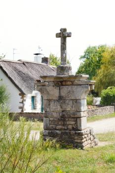 old stone cross in village de Breca, in Briere Regional Natural Park, France