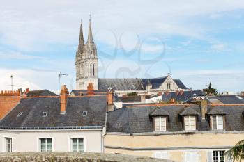 tower of Saint Maurice Cathedral and roofs of houses in Angers city, France